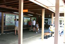 Visitors browse through the exhibits on the patio outside the visitor center.