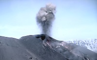 Small burst of incandescent lava fragments erupted by cinder-and-spatter cone within Veniaminoff caldera, Alaska