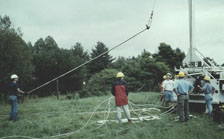 USGS scientists positioning drill stems so equipment can be lowered into a bedrock well to conduct a tracer test in fractured rock. A series of tracer tests were conducted to identify interconnected fractures at the site