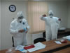 State veterinarians practicing the proper donning of Personal Protection Equipment
