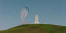 Six Blue Angles jets flying over the monument on top of Kill Devil Hill.