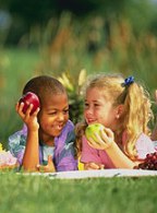 Photo of children eating apples.