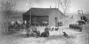 Homesteaders in front of sod house