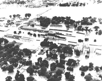 The Kansas River (at top) 
              overflows its banks and surrounds the Rock Island Railroad Station, in center 
              (photo courtesy of G.L. Sardou, Topeka, Kansas).