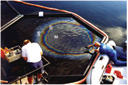 Overhead view of a test with oil, being conducted in a boomed area on the water.