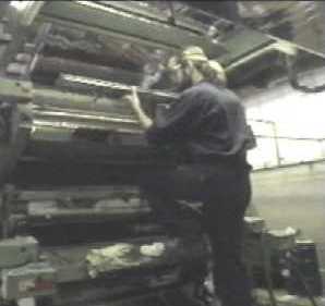 A technician installs a doctor blade which may improve print quality while decreasing ink usage.