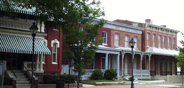 Buildings on Leigh Street, Maggie Walker's home has green and white striped awnings.