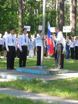 A camper raises the Russian flag during opening ceremony of the CIVITAS-sponsored civic youth competition