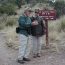 Hikers check their map at a trail junction