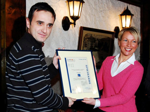 USAID Communications Director Olya Catto (right) presents the Award for Best Electronic Media Program to Mladen Cadikovski of A1