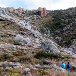 Two hikers climb the Lost Mine Trail on a frosty winter day