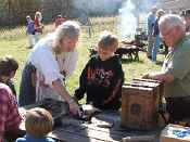 Visitors learn how people influenced wildlife populations of today at a reenactment of a rendezvous at Tamarac NWR. 
- USFWS photo by Denis Mudderman