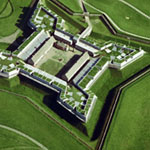 Fort Stanwix arial view from north. The star shaped- four cornered fort and multiple wooden white buildings within are set off against the deep green grass they sit upon.