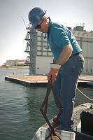 Photo - Using dredge to take a harbor sediment sample