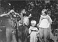 H0023-2. Gerald R. Ford, Jr., his half-brother Tom Ford and cousins Gardner and Adele James enjoy some watermelon. 1922.