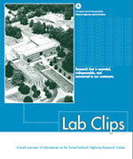 Photo 1.  Front Cover. This photo shows an aerial view of the Turner-Fairbank Highway Research Center facility with the surrounding landscape. The photo is in black and white.