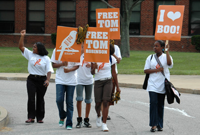students mock picketing carrying signs saying Free Tom Robinson and on saying I Love Boo