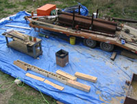 USGS scientists processed cores for later analysis of trichloroethylene (TCE), dichloroethylene (DCE), and vinyl chloride in the cores (circa 2005). A blue tarp was laid on the ground to capture any spills of potentially contaminated materials from the core