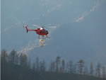 helicopter seeding a burned area.