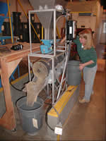woman working with a seed cleaning equipment.