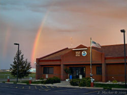 The NWS office in Sioux Falls, SD beneath an early morning rainbow.  Click image to enlarge.