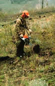 Photo of a man holding a hawk scarifier.