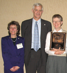 Photograph: Mary Sue Fisher (right), Jack Adams Award recipient, poses with Joel Holtrop (US Forest Service Deputy Chief for NFS; center) and Anne Zimmermann (USFS/WFW Director; left)