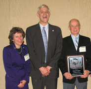 Photograph: Thomas Skinner (right), Jack Adams Award recipient, poses with Joel Holtrop (US Forest Service Deputy Chief for NFS; center) and Anne Zimmermann (USFS/WFW Director; left) at the North American Conference award ceremony.