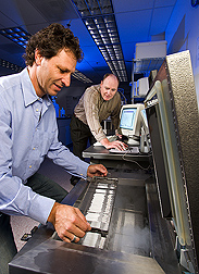 Brazilian geneticist (left) and ARS animal geneticist prepare to cryopreserve germplasm in a computerized programmable freezer: Click here for full photo caption.