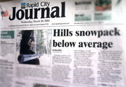 Rapid City Journal Cover with photo of forest service employee measuring snow