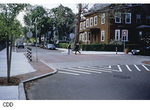 This raised intersection replaced a traffic signal. In the morning this area is crammed with students walking to Morse Elementary School, just out of view to the left.