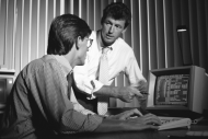 Photo of two men at a computer