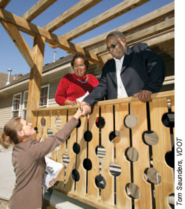 VDOT right-of-way agent Joanne K. Wilmans talks with homeowners Irene and William Newsome. Photo: Tom Saunders, VDOT.