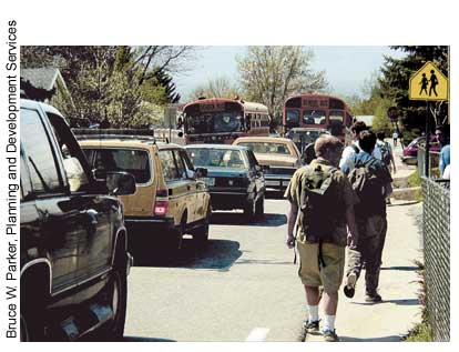 Scenario planning depends upon increased understanding of social and transportation trends, including safety. This photograph of children walking to school along a busy street clearly illustrates the need to address conflicts between pedestrians and automobiles.