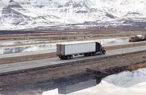 Cover Photo: Photo depicting a tractor trailer operating along a section of rural freeway.