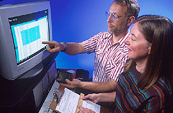 Photo of ARS scientists William Horn and Nancy Keim reviewing study data on computer