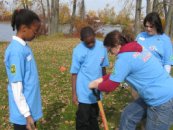 Greening of Detroit Ex. Director Rebecca S. Witt on right helps plant one of 2500 trees during Carbon Neutral Project of Detroit SuperBowl