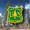 A forest scene overlain with a Forest Service shield
