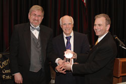 HBF Chairman Joel Rosen and HBF President Dr. Timothy Block present award to Dr. Brian McMahon