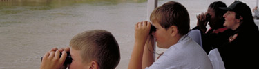 Kids looking though binoculars to see the wonders of the big Mississippi