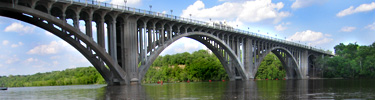 A bridge spans the Mississippi River between wooded shores.