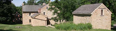 The historic Sibley House sits amid trees not far from the Mississippi River.