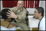 Photo thumbnail: CDR Thomas White treats a patient in Colombia.