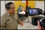 Photo thumbnail: Acting Surgeon General RADM Kenneth P. Moritsugu is interviewed by Public Affairs Office personnel at a pierside temporary dental clinic while Corps dental hygienists provide care.