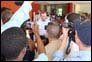 Photo thumbnail: Secretary Mike Leavitt (center) at a press conference in front of the hospital after the tour of the University Hospital de la Paix in Port-au-Prince, Haiti.