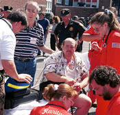 patient hooked up on electrodes being treated by emergency personnel