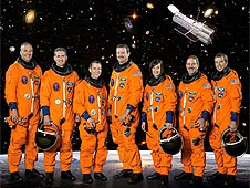 The STS-125 crew in orange launch and entry suits