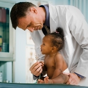 Picture of a male physician examining a baby