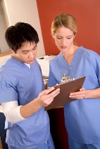 Picture of two clinicians reviewing a clipboard