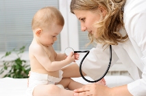 Picture of a clinician with a stethoscope examining an infant